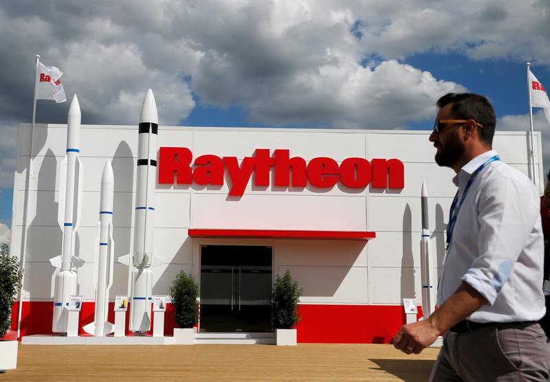 FILE PHOTO: A visitor walks past the Raytheon stand at the 53rd International Paris Air Show at Le Bourget Airport near Paris, France June 21, 2019. REUTERS/Pascal Rossignol/File Photo
