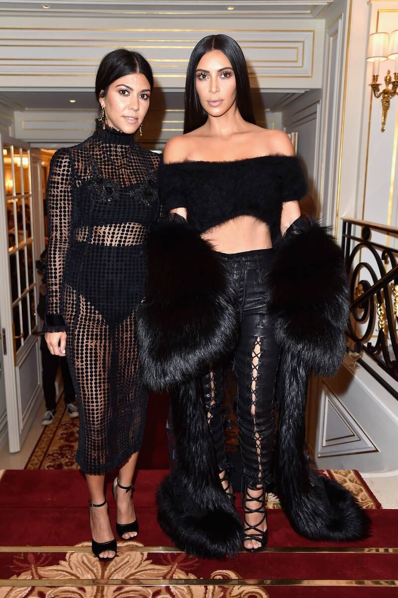 Kourtney Kardashian, left, in Georgine, and Kim Kardashian West attend Buro 24/7 Fashion Forward Initiative during Paris Fashion Week on September 30, 2016. Getty Images