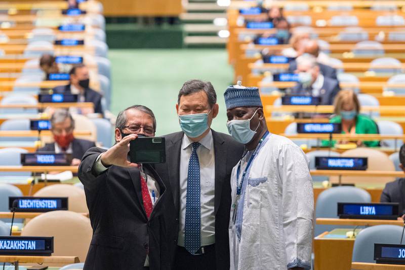 Dian Triansyah Djani, left, permanent representative of Indonesia to the UN, takes a photo with Kairat Umarov, centre, permanent representative of Kazakhstan and Tijjani Muhammad-Bande former president of the General Assembly. UN via AP