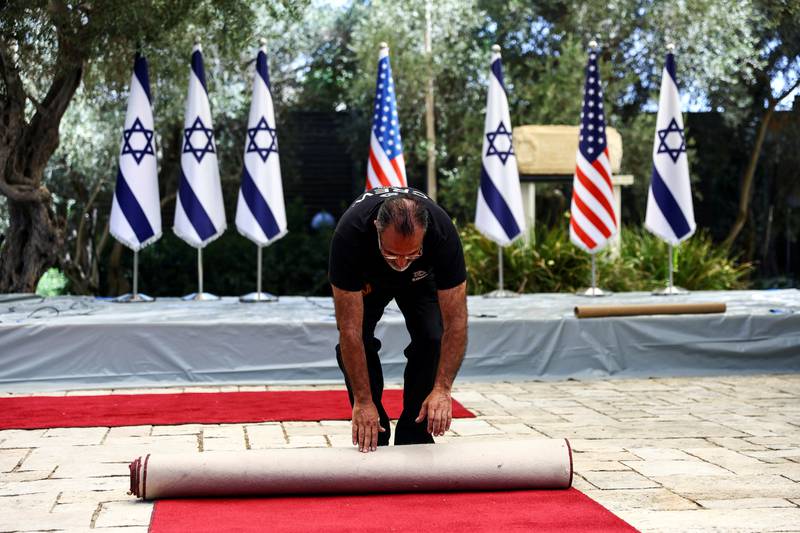 A worker checks a red carpet as part of the preparations for Mr Biden’s first visit to Israel and the occupied West Bank since assuming office. Reuters