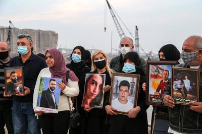 epa08919101 Relatives of victims of the 04 August Beirut port explosion pose with portraits of the deceased relatives, during a protest in Beirut, Lebanon, 04 January 2021. Relatives of people who died in the massive Beirut Port explosion on 04 August 2020 expressed their protest against the no-show of the Lebanese finance and public works ministers before a judge investigating the explosion. Former ministers are charged with negligence leading to deaths over the 04 August explosion at Beirut port, in which at least 200 people were killed and more than 6,000 were injured when a massive blast, believed to have been caused by an estimated 2,750 tons of ammonium nitrate stored in a warehouse, devastated the port area of Beirut and several parts of the city.  EPA/NABIL MOUNZER