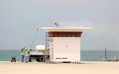 Dubai, United Arab Emirates - Reporter: N/A: People clean the buildings on the public beach. Monday, March 30th, 2020. Dubai. Chris Whiteoak / The National