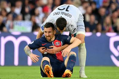 Clermont's Maxime Gonalons helps Lionel Messi to his feet. AFP