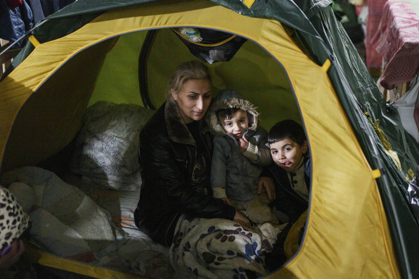 A migrant family on the Belarusian side of the freezing border with Poland. AP 