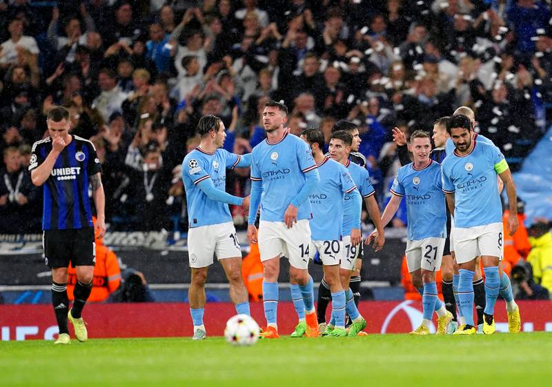 Manchester City players celebrate after FC Copenhagen's Davit Khocholava scores an own goal to put them 3-0 ahead. PA