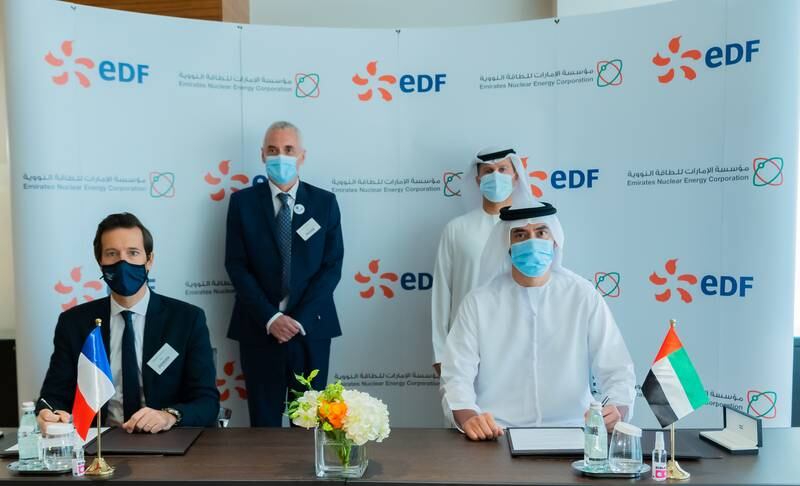 Ahmed Al Mazrouei, vice president, research & development, Enec, signs the agreement with Laurent Clement, chief executive, EDF Middle East, in the presence of Enec chief executive Mohamed Al Hammadi and Hervé Maillart, head co-ordinator of the French nuclear industry at EDF at the e-Fusion event in Dubai. Source: Enec