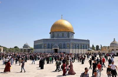 Palestinians gather around the Dome of the Rock shrine at the Al Aqsa Mosque compound, after Friday prayers. AFP