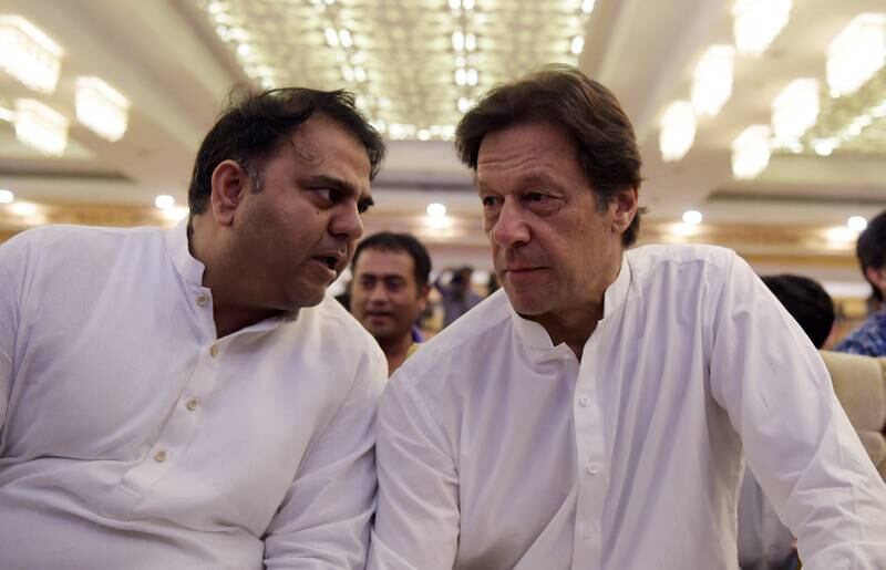 Imran Khan speaks with Fawad Chaudhry in Islamabad on July 9, 2018. AFP
