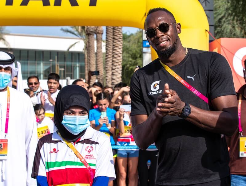 Usain Bolt poses with Emirati athlete Hamda Hosani, who has 17 Special Olympic medals under her belt, at Expo 2020 Dubai. Victor Besa / The National.