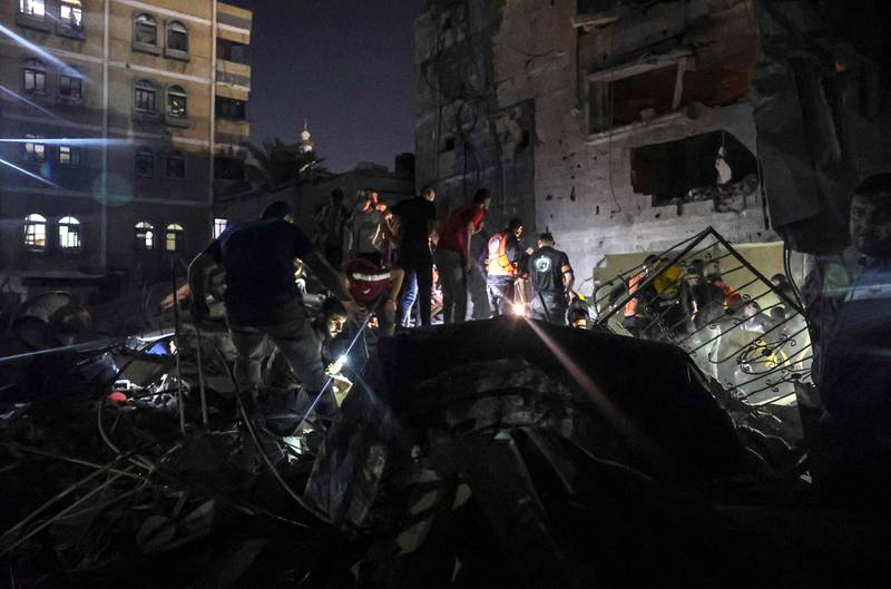 Palestinians search for casualties in the rubble of a residential building in the southern Gaza Strip. AFP