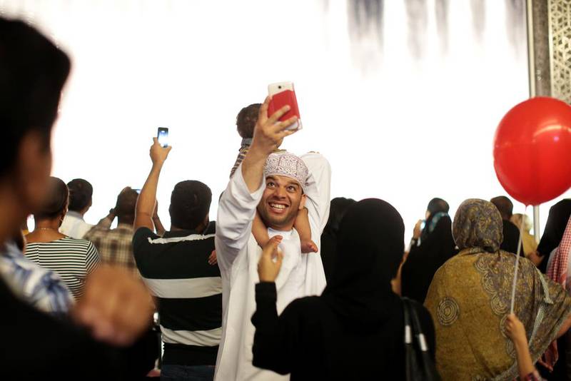 Dubai residents take pictures by Dubai Mall. Christopher Pike/ The National