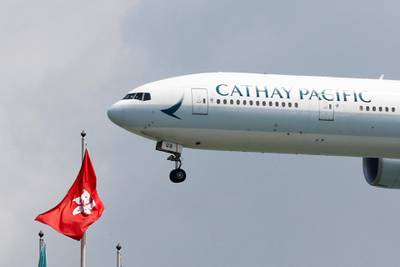FILE PHOTO: A Cathay Pacific Boeing 777-300ER plane lands at Hong Kong airport in Hong Kong, China August 14, 2019. REUTERS/Thomas Peter/File Photo