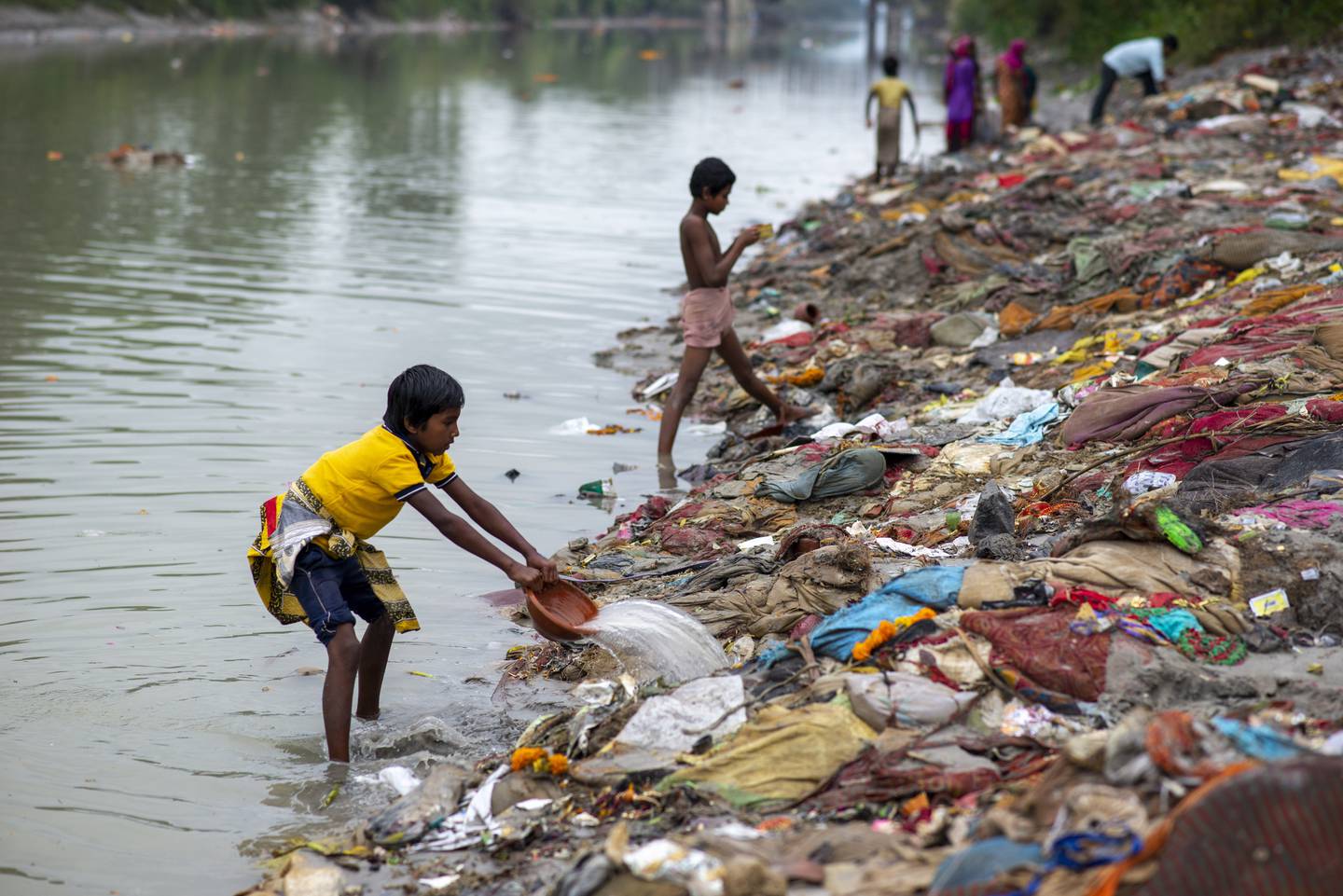 A boy rinsing salvaged waste on the banks of the Ganges Canal at Muradnagar in Uttar Pradesh state. The canal links the Ganges and Yamuna rivers and is used mainly for irrigation. Getty Images