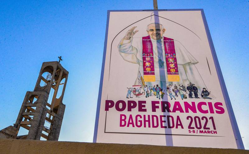 A sign welcoming Pope Francis hangs outside the Syriac Catholic Church of St Thomas in Qaraqosh. AFP