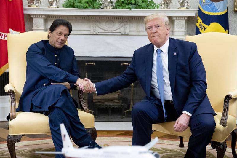 Donald Trump shakes hands with Imran Khan during a meeting in the Oval Office of the White House. Bloomberg