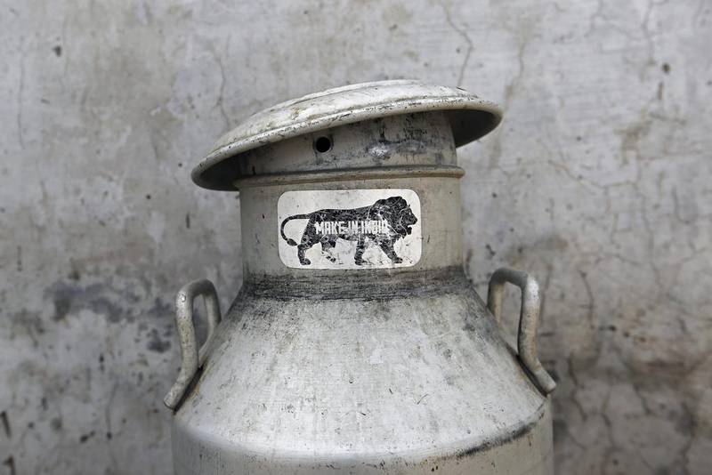 A 'Make In India' sticker is seen on a an empty milk urn at a cow shelter where urine is collected and processed in Bulandshahar, Uttar Pradesh, on June 17, 2016. Anindito Mukherjee/Bloomberg