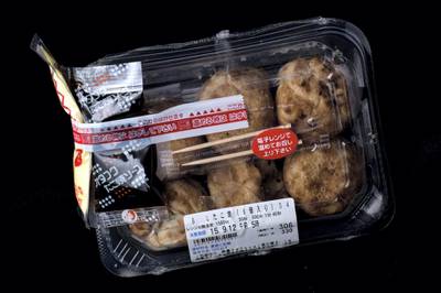 TOKYO, JAPAN - SEPTEMBER 11: A box of octopus balls or "takoyaki"  from a convenience store or "konbini" is pictured on September 11, 2015 in Tokyo, Japan. Japan's Konbini stores (convenience stores) are famous for their high quality food, available 24hours a day. Many of the stores have 2-5 deliveries per day of fresh, often locally sourced products all prepared in ready to eat packaged meals, catering mostly to office workers and travellers. As of July 30, 2015, Japan's minimum wage was 780yen (approx. $6.45 USD) lower than in many countries, including the United States. With a small 2.3 percent rise in minimum wages expected this year, the cheap convenience store meals popularity has seen a steady rise in sales, fast food and daily food sales of convenience stores for 2014 was 3,807,614 million yen, according to the Ministry of Economy, Trade and Industry.  (Photo by Chris McGrath/Getty Images)