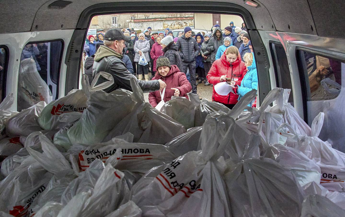 Volunteers distribute humanitarian aid to residents on the outskirts of Kharkiv, Ukraine on December 16. EPA