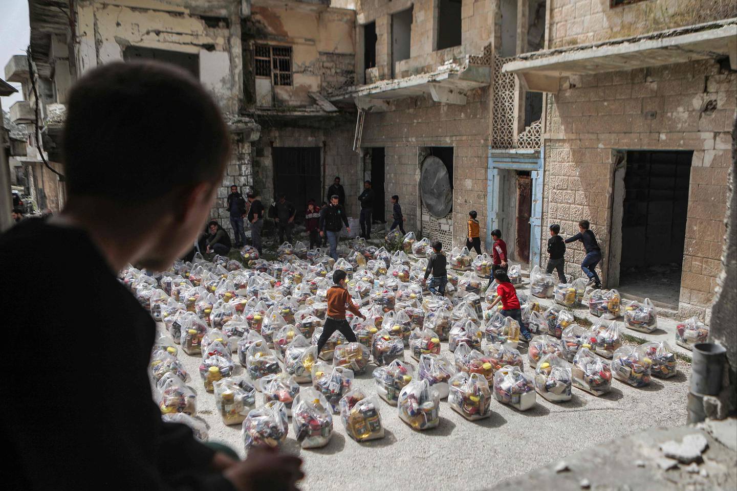 Humanitarian food aid packages are delivered in the town of Al Najieh, in Syria's rebel-held north-western Idlib province. AFP