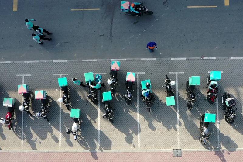 Motorbikes of a delivery company line up in Dubai. AFP