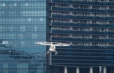 A Volocopter air taxi flies past a building during its test flight in Singapore. The Volocopter is a manned, electric powered multicopter.  EPA