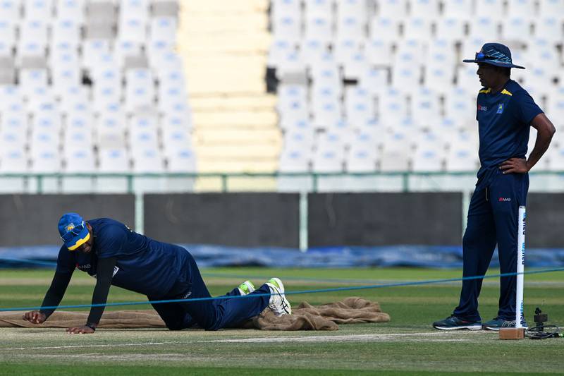 Sri Lanka player Angelo Mathews inspects the pitch on the eve of the first Test in Mohali. AFP