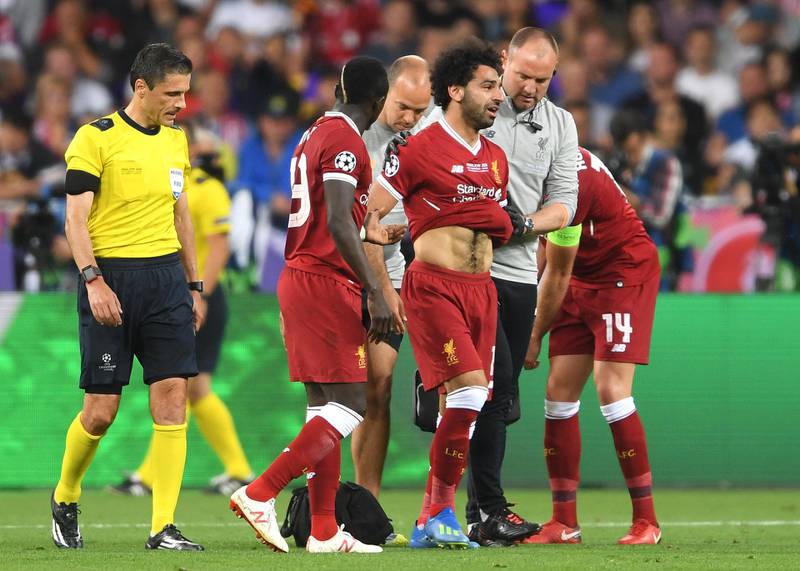 Sadio Mane consoles team mate Mohamed Salah l as he leaves the pitch injured. Laurence Griffiths / Getty Images