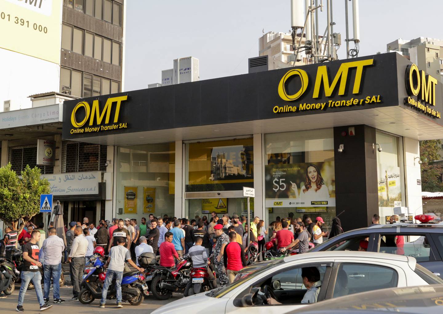 People gather in a long line at a shop in Beirut that provides money transfer services. AFP