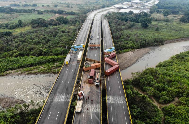 Workers remove containers on the Tiendita bridge on the border between Colombia and Venezuela, on December 14.  AFP