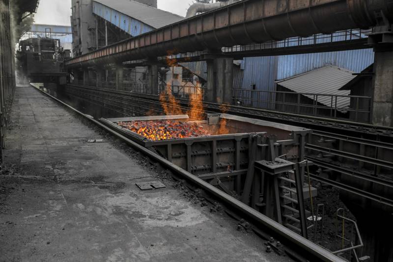 Flames rise from a wagon loaded with coke at a steel factory in India. Photographer: Dhiraj Singh/Bloomberg