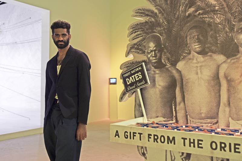 Christopher Joshua Benton with his work 'The World Was My Garden' which maps the circulation of dates as a commodity. Vidhyaa Chandramohan / The National