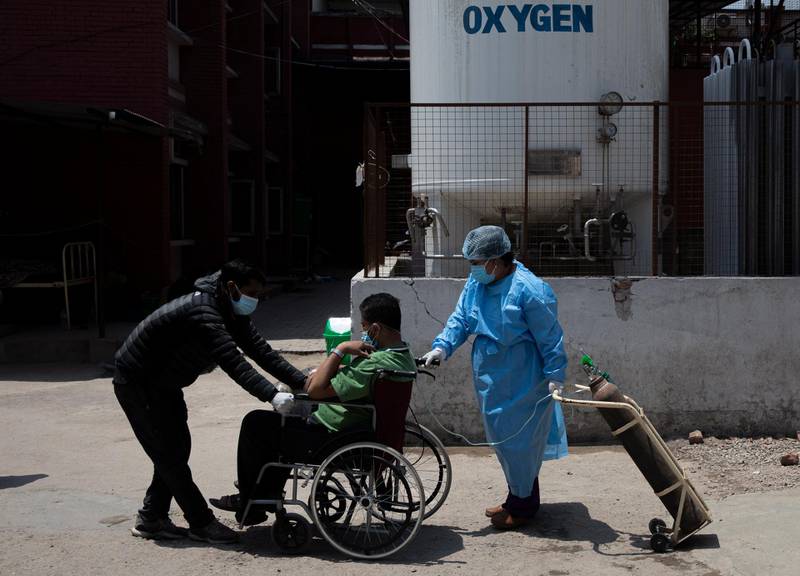 A Covid-19 patient is treated outside a hospital in Kathmandu, Nepal, as Covid-19 wards run at full capacity. EPA