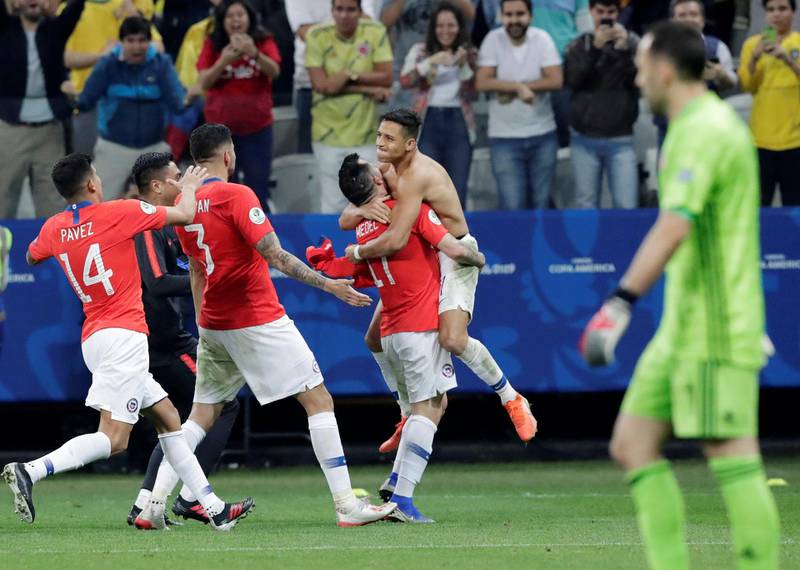 Alexis Sanchez celebrates his winning penalty against Venezeula with Chile teammates. Reuters