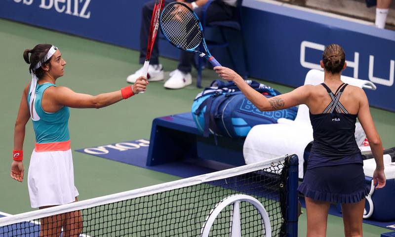 Caroline Garcia and Karolina Pliskova touch rackets after their match. AFP