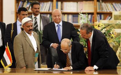 Abd Al Karim Al Iryani (centre, bending) advisor to Yemeni president Abd Rabbu Mansour Hadi (centre, in blue tie) signs the ceasefire agreement to end days of street violence, in the presence of UN special envoy Jamal Benomar (right) in Sanaa September 21, 2014. Yemen's Shiite rebels are calling for a more inclusive government. Mohamed Al Sayaghi/Reuters