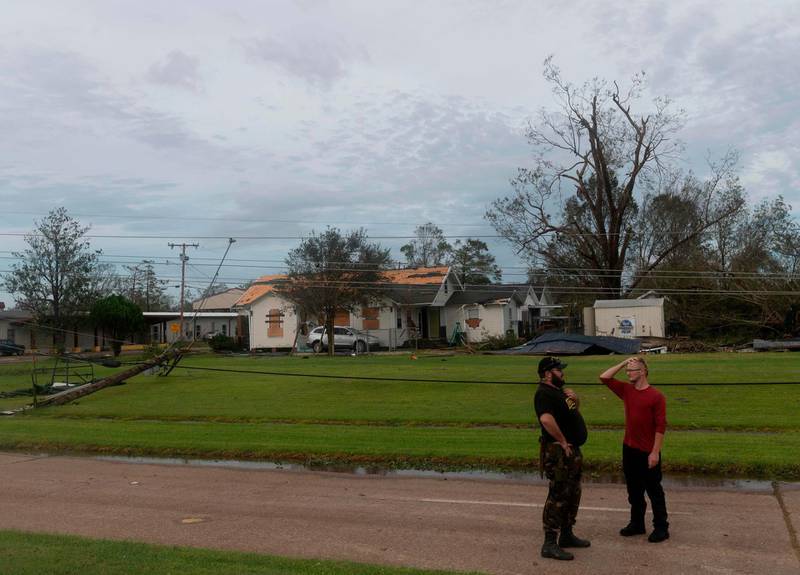 Two men react near a destroyed house after Hurricane Laura passed through in Lake Charles, Louisiana. AFP