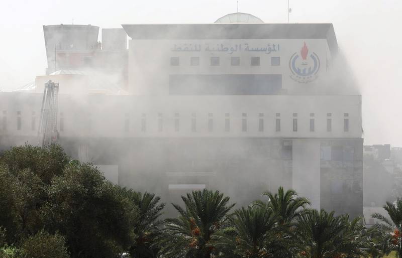 Smoke rises form the headquarters of Libyan state oil firm. Reuters