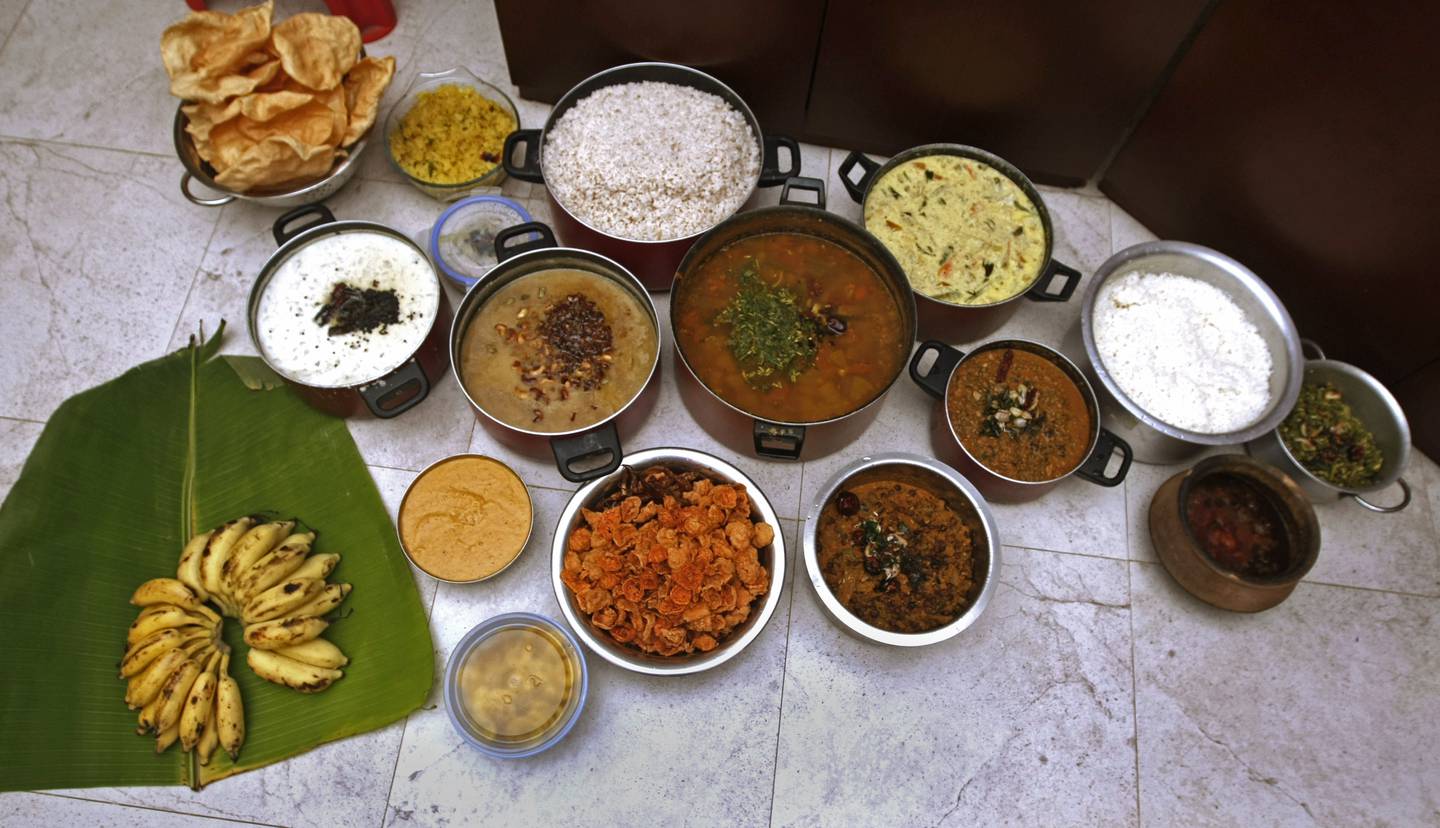 DUBAI, UNITED ARAB EMIRATES - August 29, 2012- Pappad, mixed vegetables with yogurt, snake gourd, Ashguard (white pumpkin) with coconut milk, sweet ripe mango curry and banana and rice chips are some of the dishes served during an Onam celebration at Vivek Anand's home in Abu Hail, Dubai, August 29, 2012. (Photo by Jeff Topping/The National) 