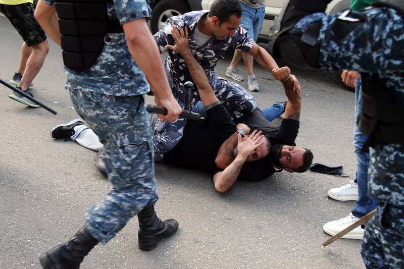 Riot police intervene as an anti-government protester tackles an Hezbollah supporter during clashes with anti-government protesters in Beirut, Lebanon, on Tuesday, Oct. 29, 2019. "I tried throughout this period to find a way out so we could listen to the people’s voices and protect the country," Lebanese Prime Minister Saad Hariri said hours after supporters of Iranian-backed Hezbollah attacked anti-government protesters in Beirut and destroyed their tents. Photographer: Hasan Shaaban/Bloomberg