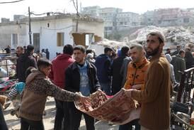 People collect donations for rebuilding a mosque in Maland, Idlib, after it collapsed in the earthquake. EPA