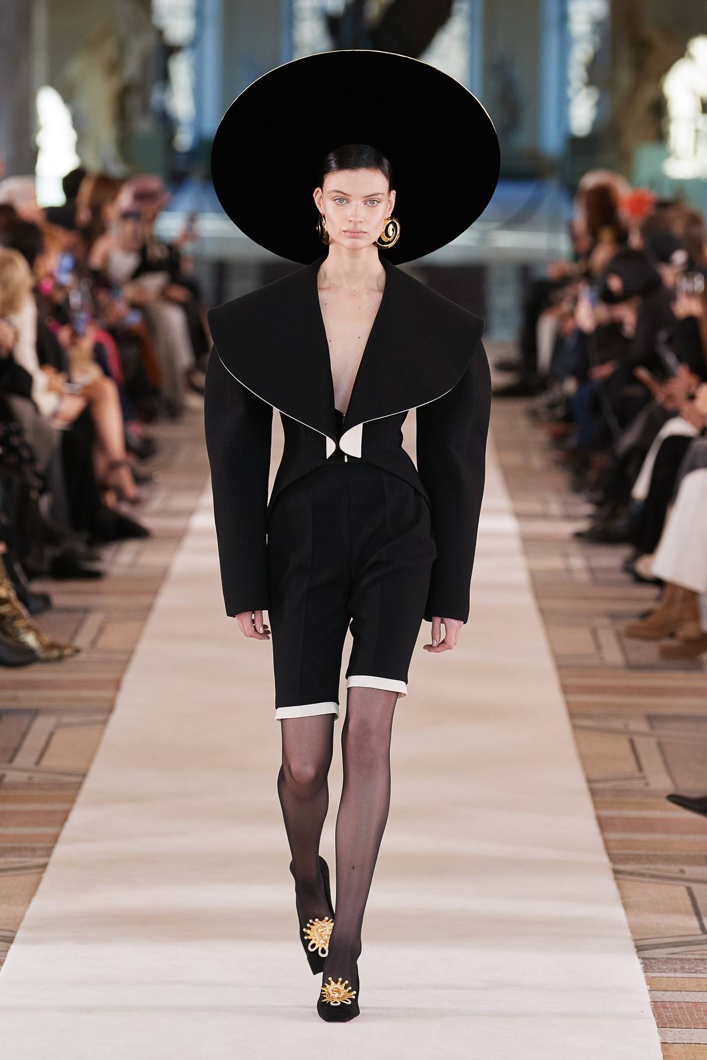 A hat with the circumference of a small planet, Schiaparelli spring/summer 2022 haute couture. Photo: Schiaparelli