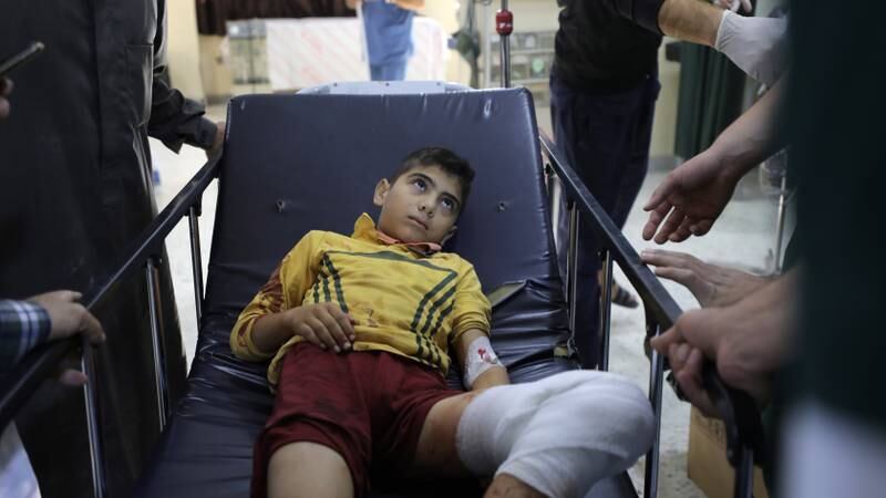 A boy lies injured after shelling on Maram camp for internally displaced people in Idlib, Syria. The explosion  early on Sunday killed at least six people - including two children - and wounded dozens, reports said. EPA