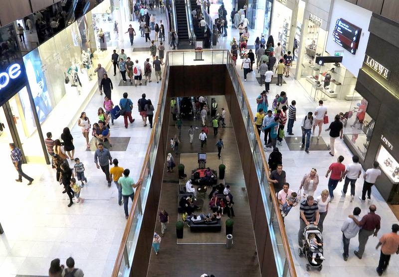 Shoppers at the busy Dubai Mall, a major attraction for residents and tourists alike. Jeffrey E Biteng / The National