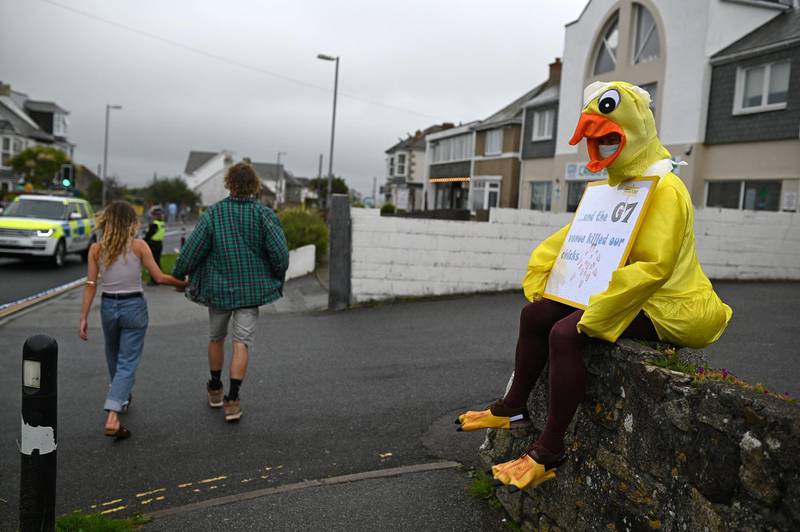 A local resident dressed as a chick, protests against the G7 summit in St Ives. AFP