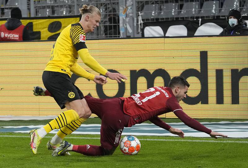 Dortmund's Erling Haaland, left, fouls Bayern's Lucas Hernandez. AP Photo