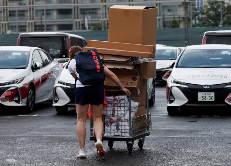 A team official of Britain transports equipment at the Olympic Village in Tokyo on Tuesday.