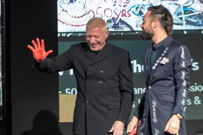 Artista Sacha Jafri and Boris Becker places a finishing hand print on one of his art works during the auction. Art on auction at the 100 Million Meals charity auction at the Mandarin Oriental Jumeirah in Dubai on April 24 th, 2021. Antonie Robertson / The National.Reporter: Rory Reynold for National