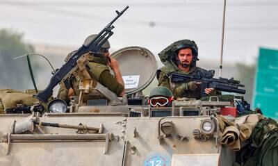 Israeli soldiers on patrol near the border with Gaza. Their generals might be preparing for a long war by besieging Hamas strongholds in an operation that could last a year, analysts have said. EPA