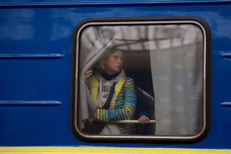 A young woman looks out the window as her train arrives from Pokrovsk, in the east of Ukraine, to Lviv in the country's centre. Getty