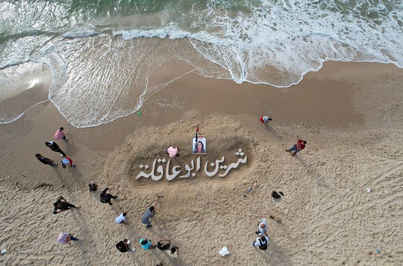 A sand sculpture reads 'Shireen Abu Akleh' on a beach in Gaza city. Reuters